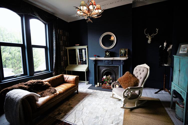 unused fireplace in a dark decor victorian build living room