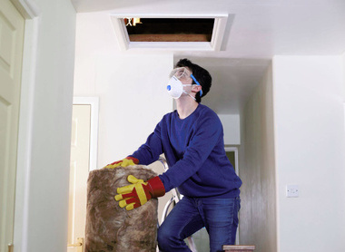 man installing loft insulation.jpg
