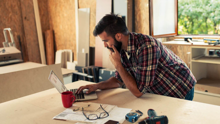 iStock-840979094 - builder carpenter man young laptop indoors check.jpg 1