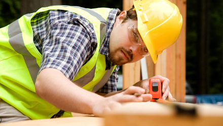 iStock Building materials site man tape measure.jpg