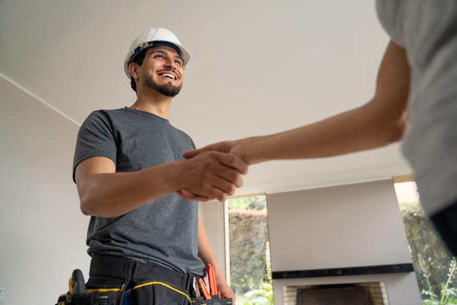 Builder greeting homeowner for a quote