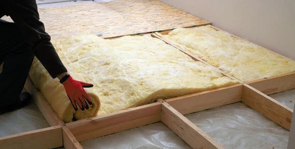 Installing rolls of loft insulation