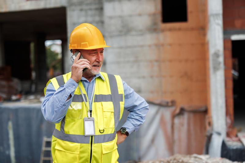 Builder taking call from absent employee