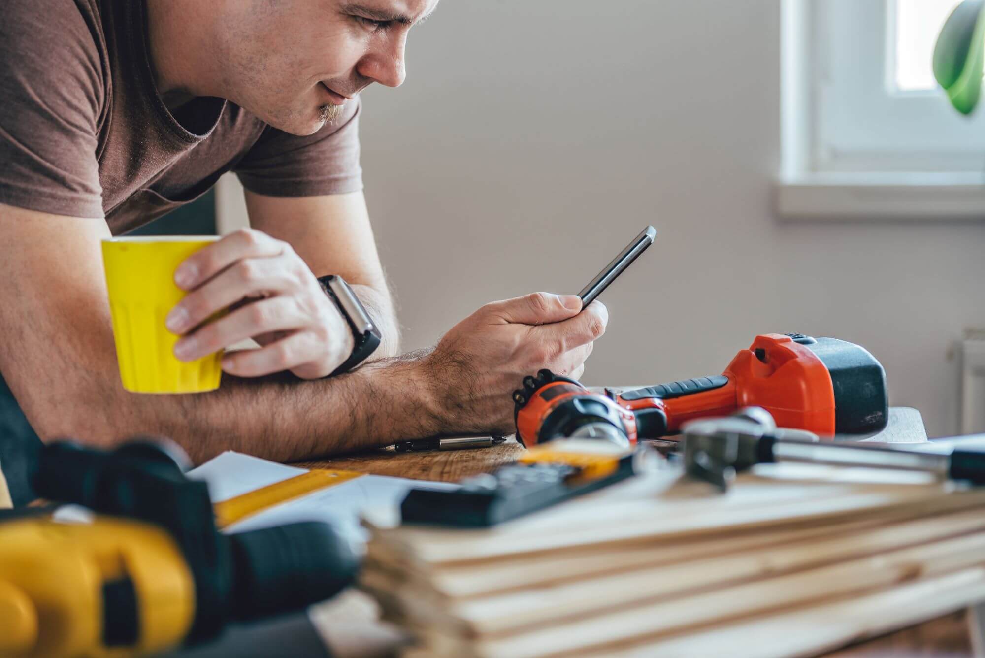 Builder looking at phone