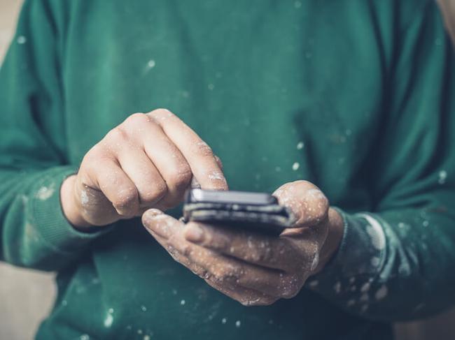 Builder using social media on mobile phone