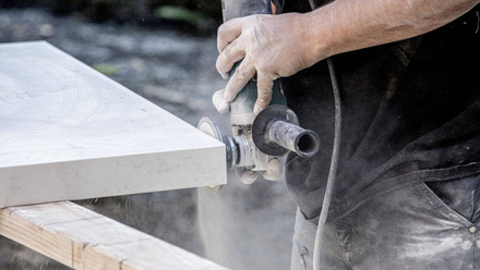 Builder using power tool to polish quartzite worktop edge.jpg