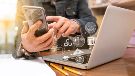 Builder using AI on phone and laptop.jpg