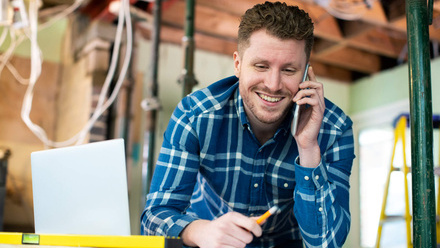 iStock Builder happy phone building site.jpg