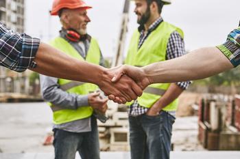 iStock builders handshake smiling building site.jpg